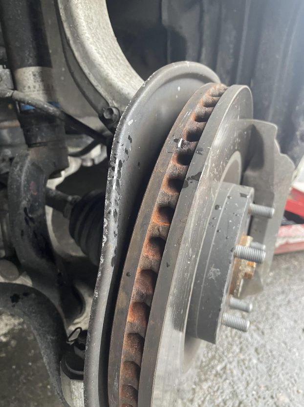 bent brake dust shield rubbing against brake rotor creating wheel speed noise