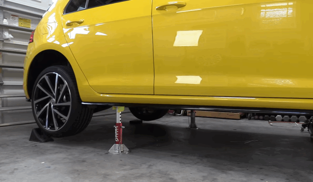 Image of a car being lifted on a jack for a rack and pinion replacement
