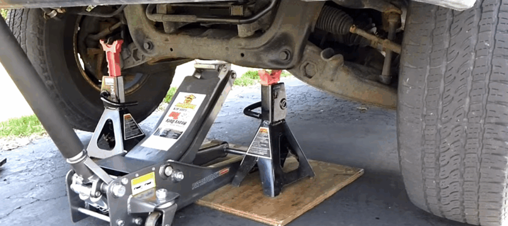 Image showing car lifted on a jack before flushing power steering fluid