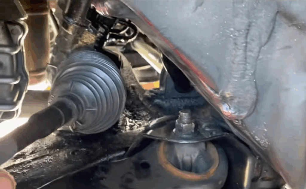 Photo showing steering rack mounting bolts being removed