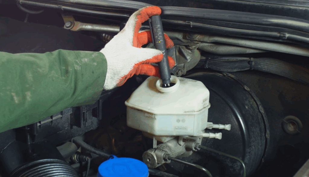 Image showing a mechanic checking power steering fluid