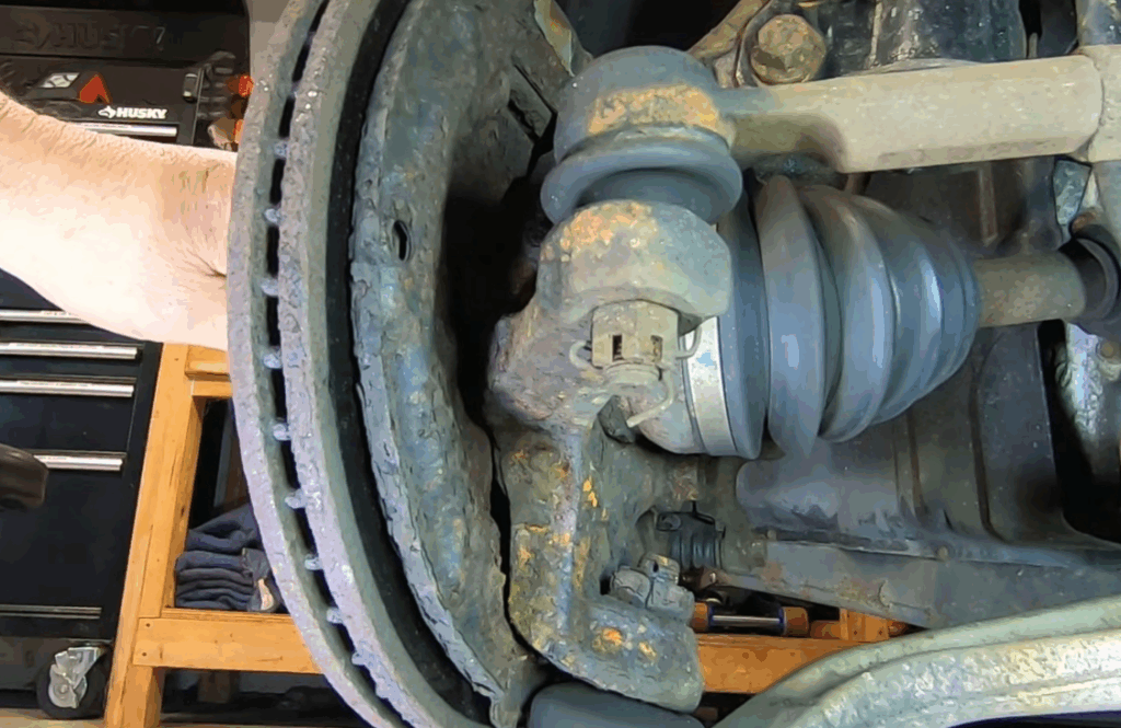 Image showing mechanic removing wheel and brake components